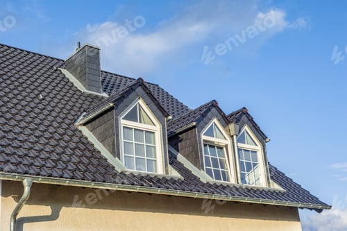 Preview: Dormers on the grey slate roof with the sky in the background