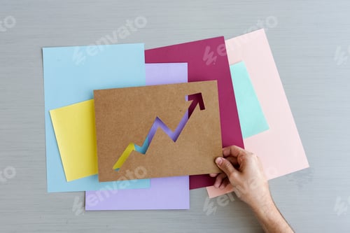 Preview: A hand holding a cut out arrow paper design