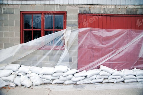 Preview: Sandbags and glass sheet on building wall