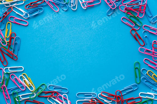 Preview: top view of frame with colorful paper clips on blue