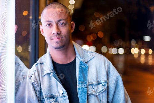 Preview: Frontal view of a young latin man in the city