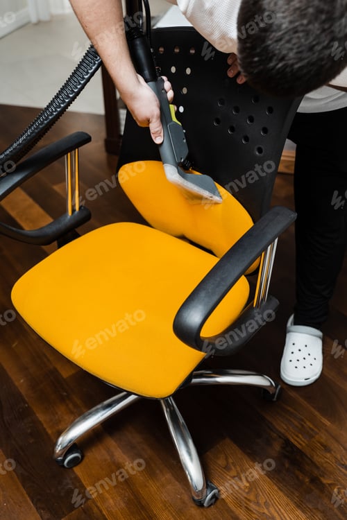 Preview: Armchair dirt removed by professional cleaner using vacuum machine, home cleaning