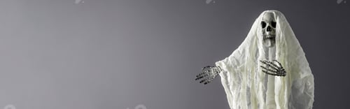Aperçu: Creative Halloween Concept. Horrible ghost on gray background points his hand to an empty space.