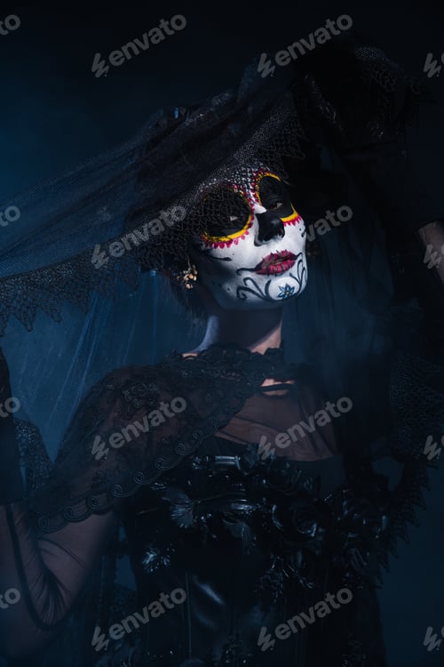 Preview: woman in halloween costume and creepy makeup posing with black lace veil on dark blue background