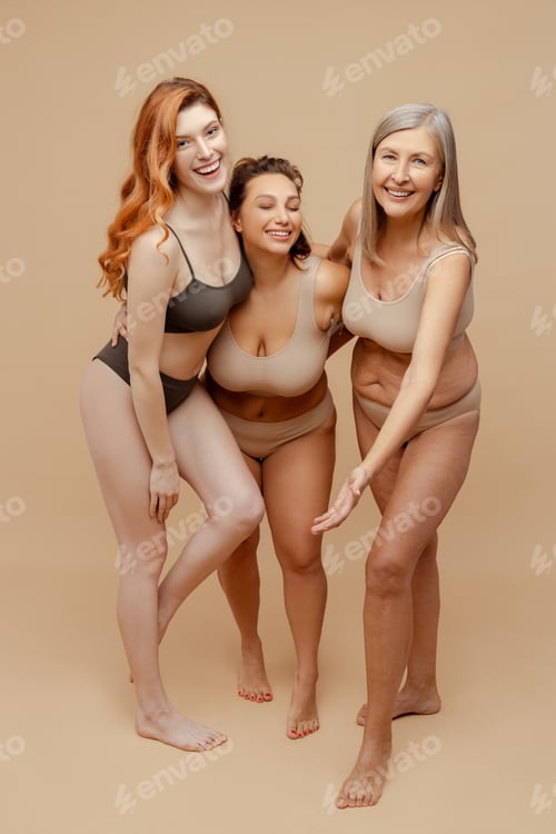 Preview: Group of attractive, multiracial smiling fashion women wearing sexy lingerie looking at camera