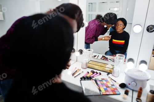 Preview: African American woman applying make-up