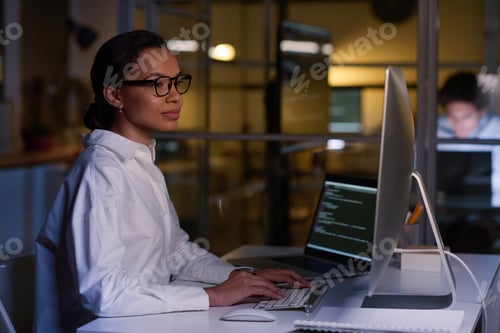 Preview: Young Woman Working On Code In Evening