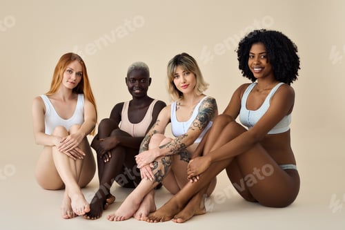 Preview: Happy diverse young women wear underwear sitting showing legs on background.
