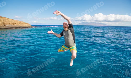 Preview: Bald man jumping into the ocean
