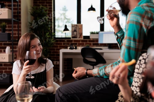 Preview: Diverse happy people at home enjoying wine party while celebrating birthday