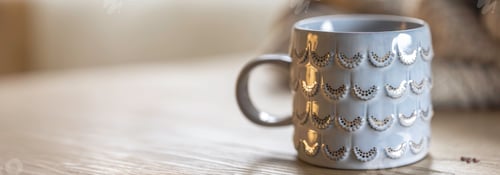 Preview: Close-up, shiny gray cup on a blurred background, copy space.