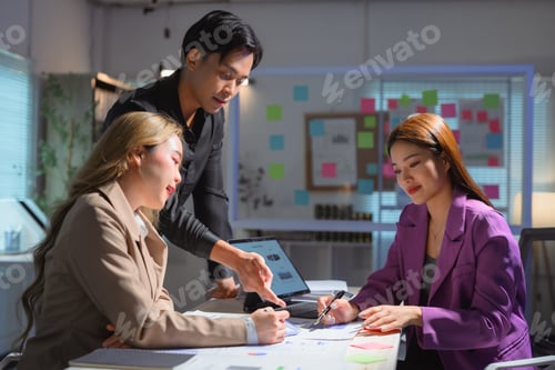 Preview: Business team analyzing financial reports in modern office setting