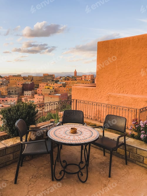 Preview: Restaurant table on terrace with amazing view of old arabic town Boumalne in Morocco at sunset