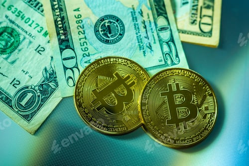 Preview: Bright bitcoin coins next to dollar bills.