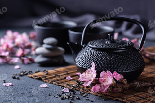 Preview: Teapot and tea cups with blooming almond tree branches