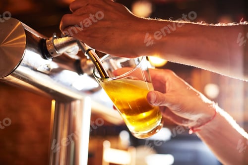 Preview: Vertical shot of a bartender dispensing beer into a glass at a pub