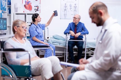 Preview: Disabled senior man looking at x-ray