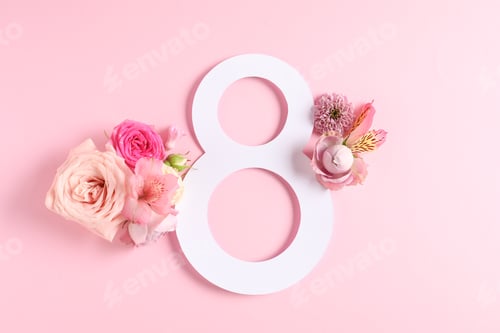 Preview: 8 March greeting card design with beautiful flowers on light pink background, top view