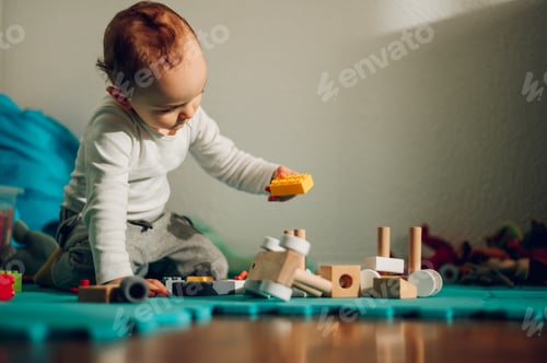 Preview: A focused child is learning cognitive and logic skills while playing with brick toys at home.