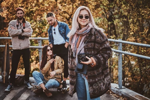Preview: Beautiful blond girl and her friends at autumn park