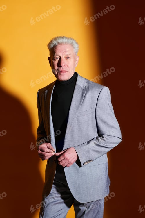 Preview: Confident mature male entrepreneur or ceo in elegant grey suit