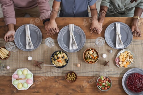 Preview: African American Family Holding Hands at Dinner Table
