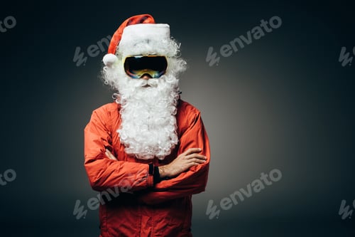 Preview: santa claus in ski mask and windbreaker standing with crossed arms isolated on grey background