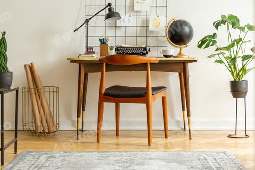 Preview: Plant next to chair and desk with lamp typewriter and globe in c