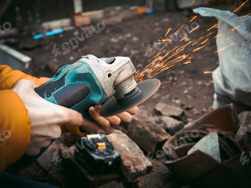 Preview: Worker Using Angle Grinder with Sparks Outside