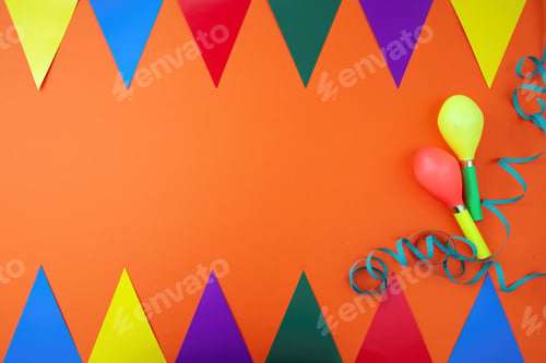 Preview: Carnival party, garland, colorful triangle flag, maraca, serpentine on orange background. Space, ad.
