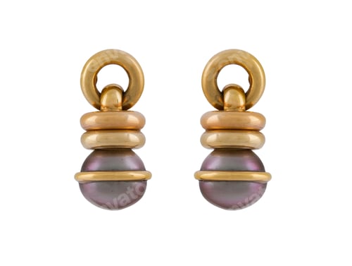 Preview: Closeup of a pair of small gold earrings with purple gemstones