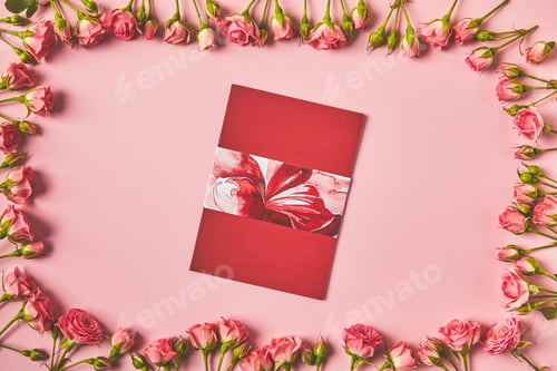 Preview: top view of frame made from beautiful pink roses and greeting card on pink