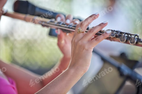 Preview: Unrecognizable Female Latina musician flutist plays music onstage at a local outdoor music festival