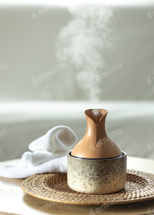 Preview: Essential oil aroma diffuser humidifier diffusing water in the air.