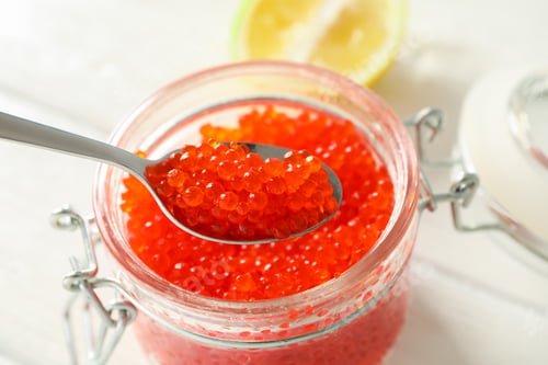 Preview: Glass jar with caviar on white wooden table, space for text