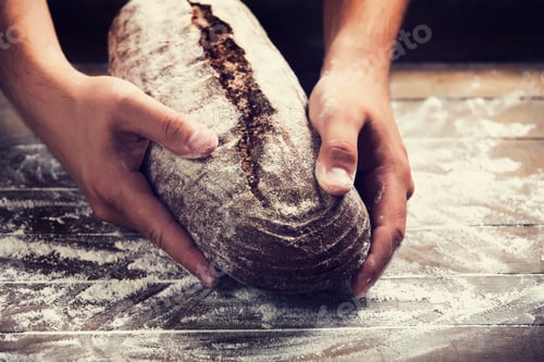 Preview: Baker's hands with a bread