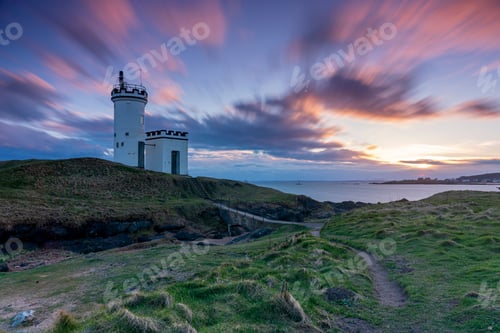 Preview: Sunset over coastal lighthouse and landscape