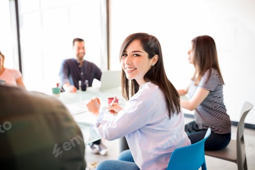 Preview: Woman in meeting room with colleagues