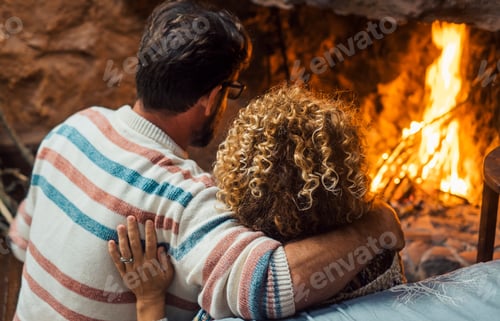 Preview: Romantic couple enjoy flame in front of fireplace in winter at home - cozy romance love