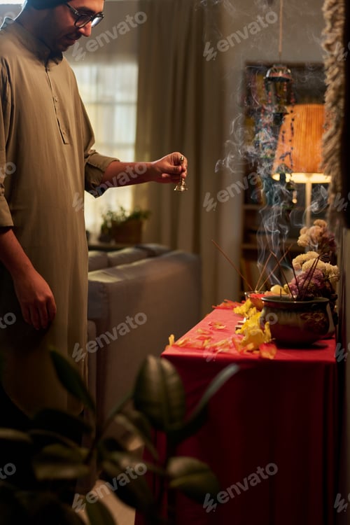 Preview: Man Participating in Traditional Ritual Indoors