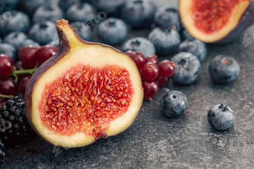 Preview: Close-up, figs in the cut among the berries.