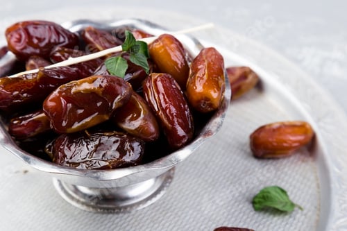Preview: Dry fruit dates on silver tray. Copy space.