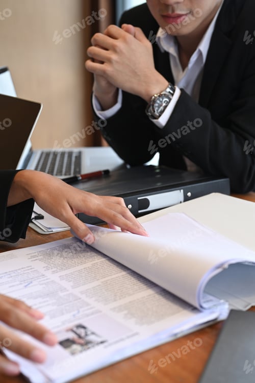 Preview: Cropped shot team of human resources reading cv resume before interview candidature.