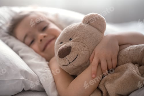 Preview: Little cute girl in bed with toy