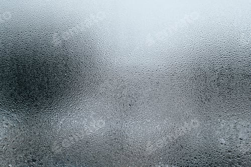 Preview: Textured surface of wet misted window glass on cloudy foggy day