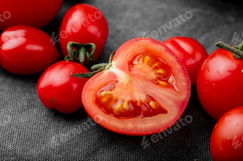 Preview: side view of sliced tomato with whole tomatoes on cloth surface
