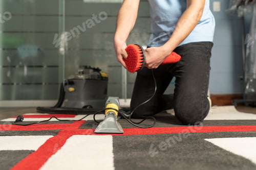 Preview: Unrecognizable laundry personnel cleaning carpet with special equipment
