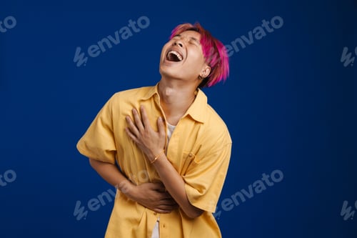 Preview: Asian boy with pink hair laughing while holding his belly