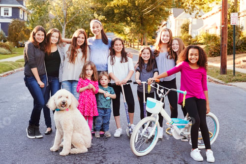Preview: Group of kids with dog smile to camera in a residential street