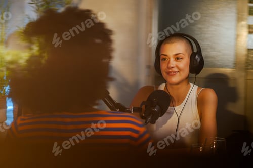 Preview: Portrait of a happy interviewer sitting in a broadcasting home studio with guest